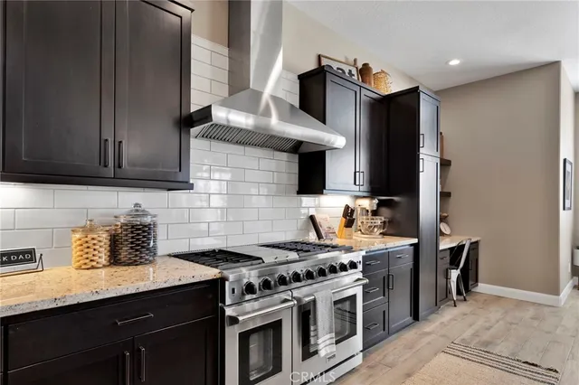 a kitchen with stainless steel appliances a stove a sink and a refrigerator