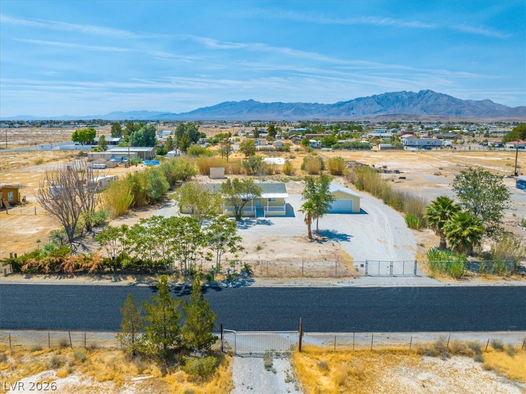 4081 Retread Road Pahrump, NV 89048 - Photo 74 of 98 A desert oasis home, set against a distant mountain range, offers serene rural living.