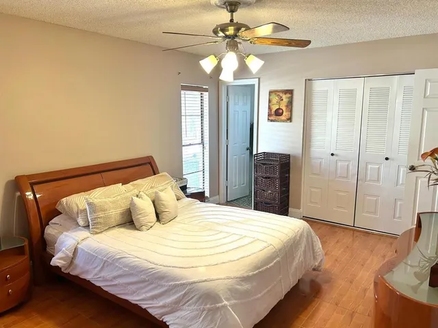 a bedroom with a bed and dresser with mirror