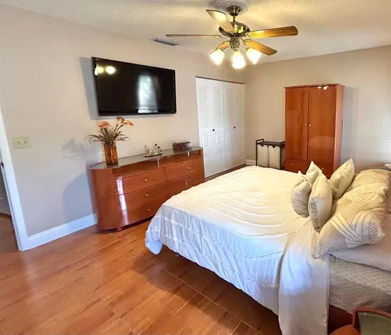 a bedroom with a bed and a flat screen tv