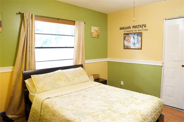 a bedroom with a bed and a window