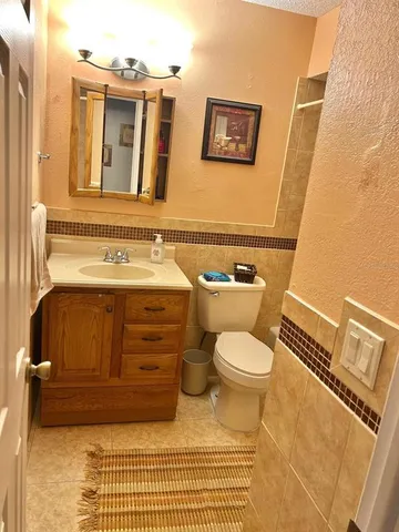 a bathroom with a sink a toilet and mirror