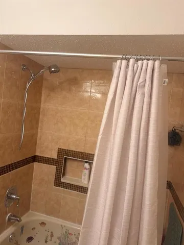 a kitchen with a refrigerator and a stove top oven