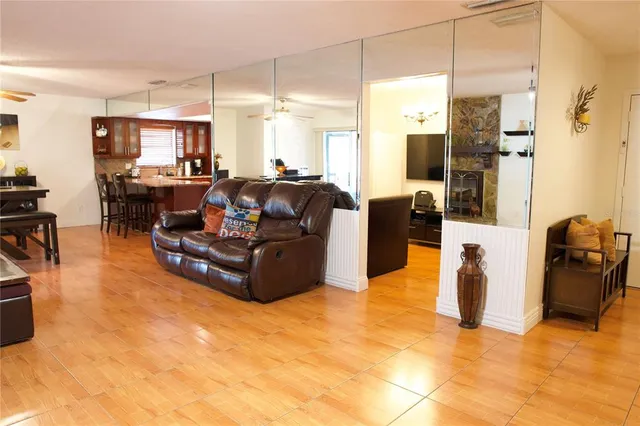 a living room with furniture refrigerator and flat screen tv