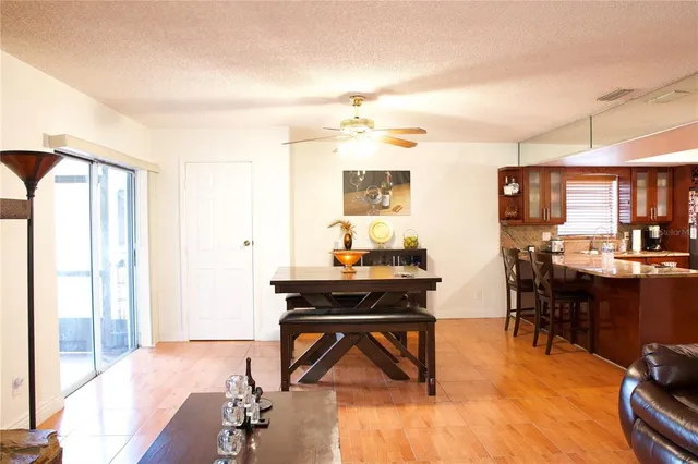 a living room with furniture a dining table and a fireplace