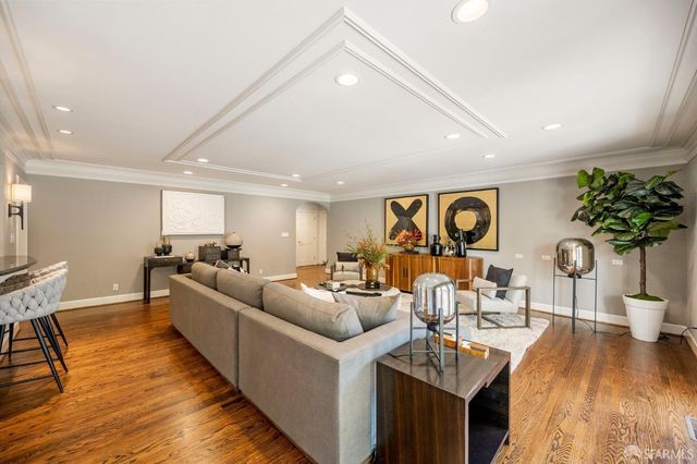 a backyard of a house with basket ball court tables and chairs