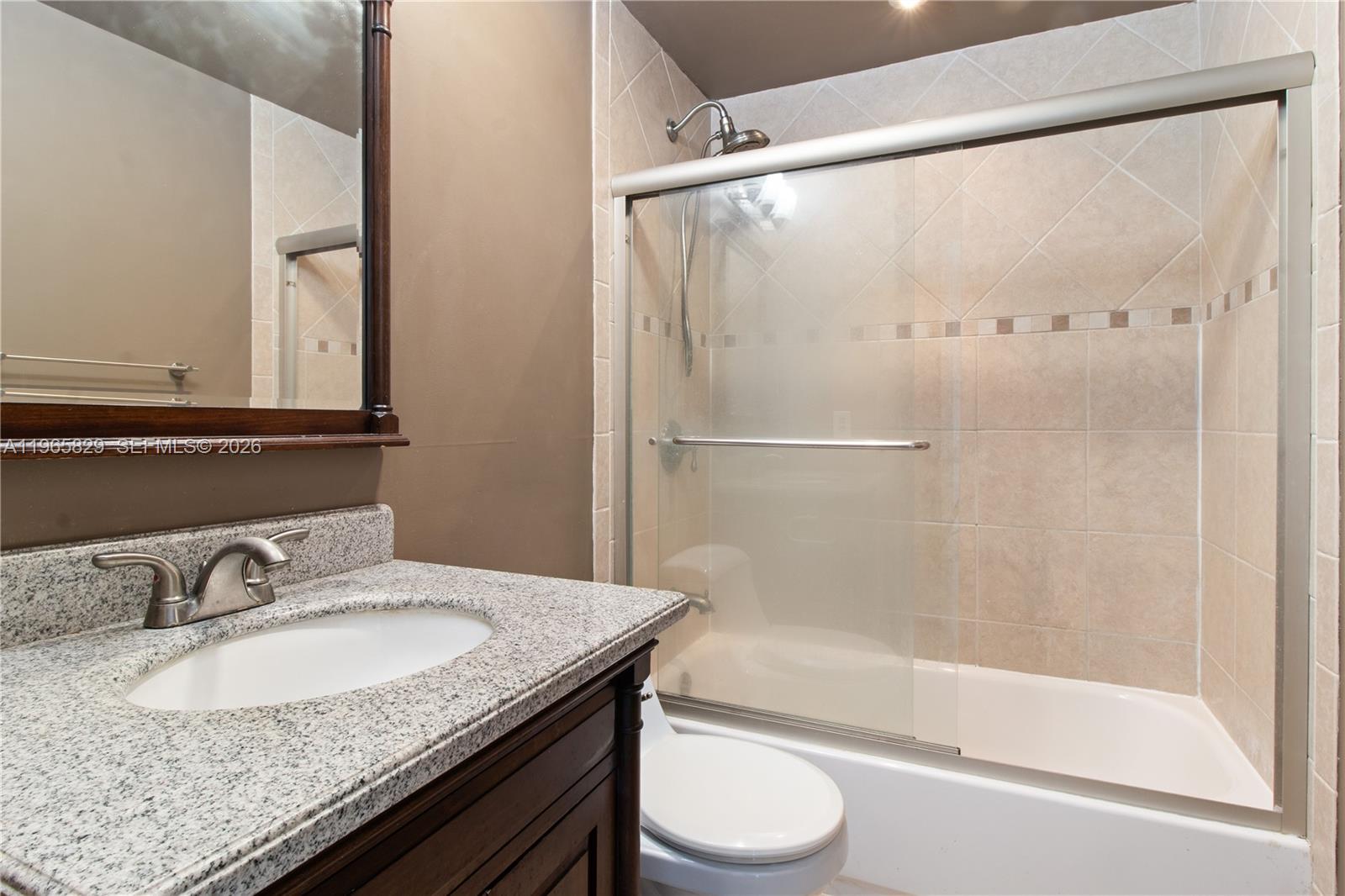 2162 West 60th Street, Unit 14203 Hialeah, FL 33016 - Photo 12 of 23 a bathroom with a granite countertop sink toilet and shower