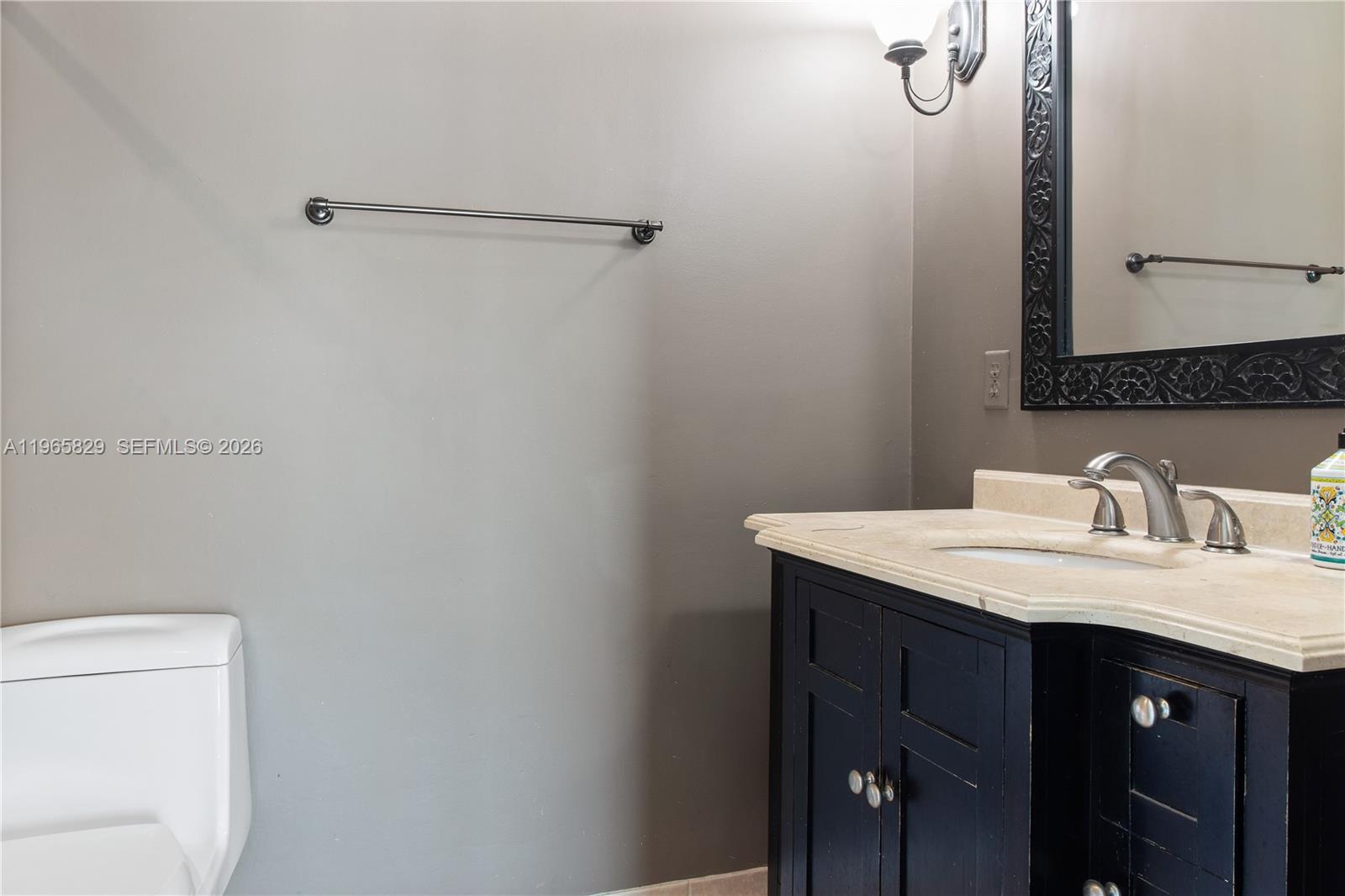 2162 West 60th Street, Unit 14203 Hialeah, FL 33016 - Photo 13 of 23 a bathroom with a granite countertop sink and a mirror