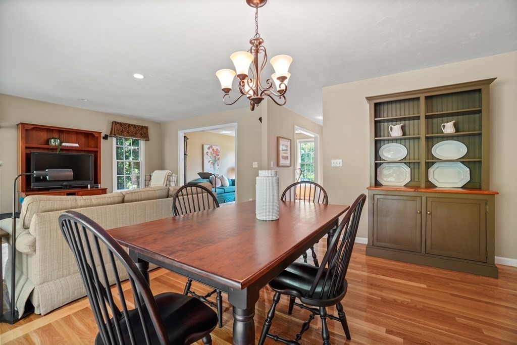 10 Sullivan Way Canton, MA 02021 - Photo 12 of 42 a view of a dining room and livingroom with furniture wooden floor a chandelier