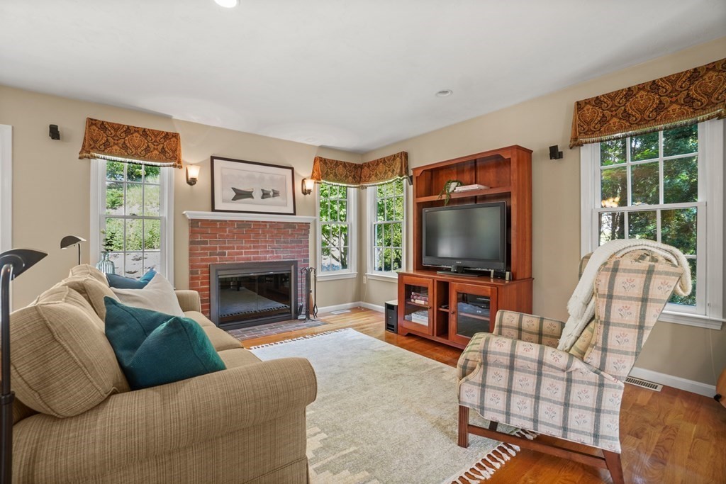 10 Sullivan Way Canton, MA 02021 - Photo 14 of 42 a living room with furniture a flat screen tv and a fireplace