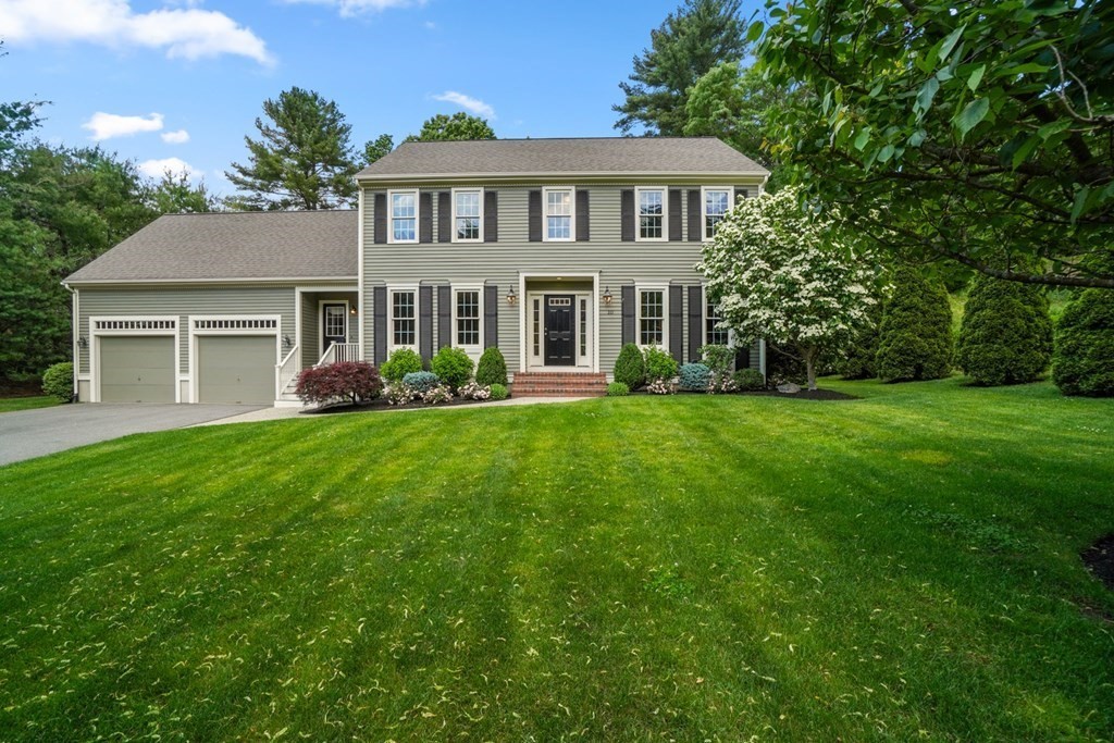 10 Sullivan Way Canton, MA 02021 - Photo 2 of 42 a front view of a house with a garden and trees