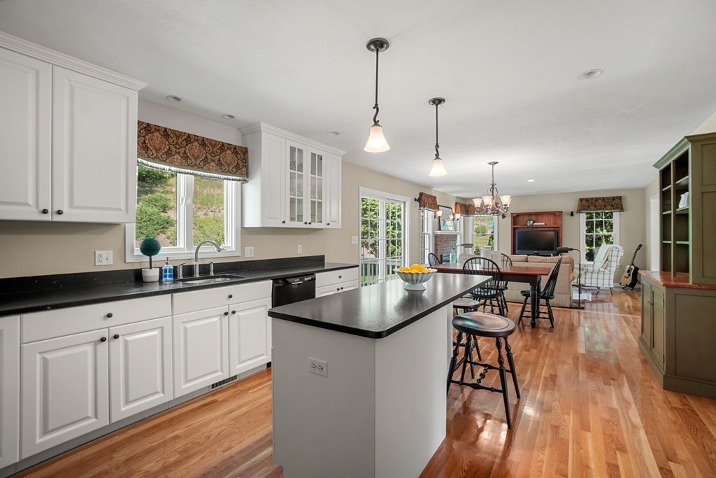 10 Sullivan Way Canton, MA 02021 - Photo 8 of 42 a kitchen with sink cabinets and wooden floor