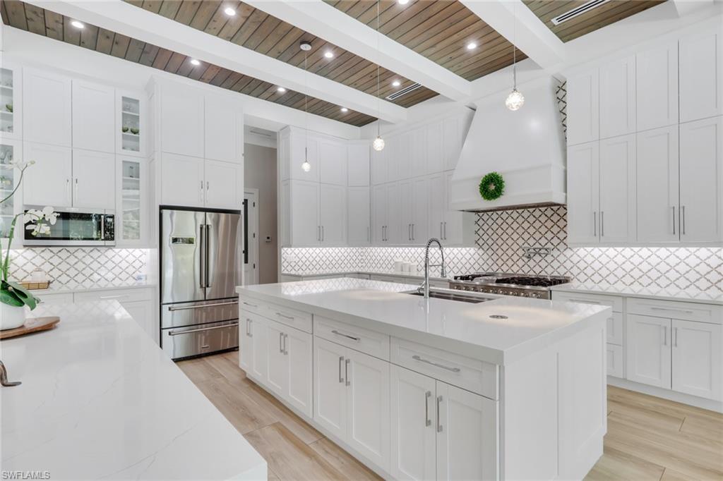 530 1st Street Northwest Naples, FL 34120 - Photo 13 of 35 a kitchen with stainless steel appliances granite countertop a sink and cabinets