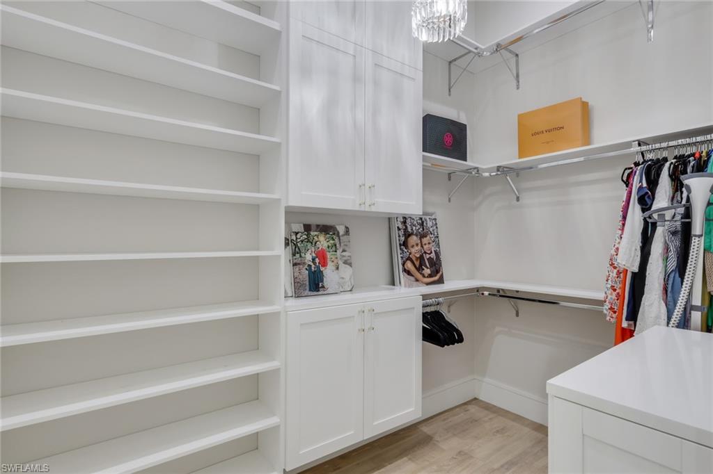 530 1st Street Northwest Naples, FL 34120 - Photo 15 of 35 a view of walk in closet with clothes and shoes