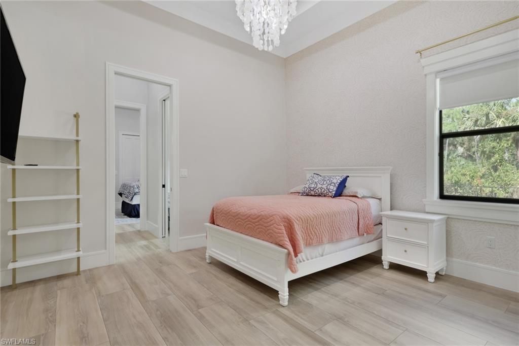 530 1st Street Northwest Naples, FL 34120 - Photo 19 of 35 a spacious bedroom with a bed and a window