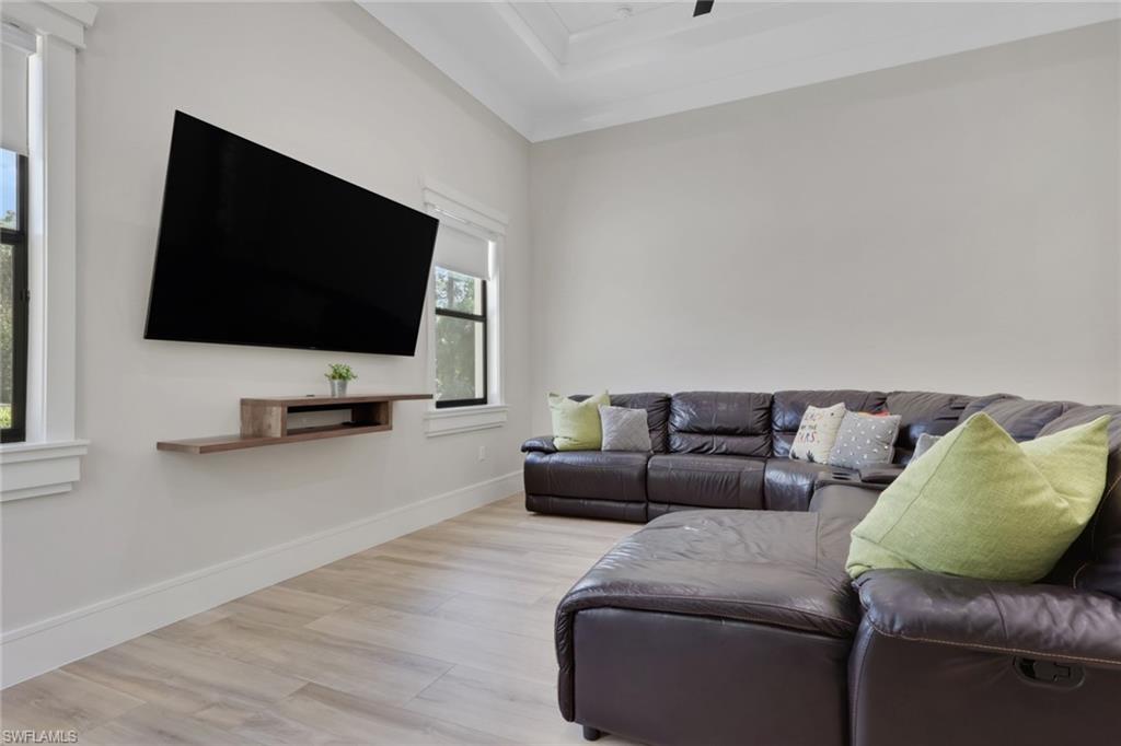 530 1st Street Northwest Naples, FL 34120 - Photo 20 of 35 a living room with furniture and a flat screen tv