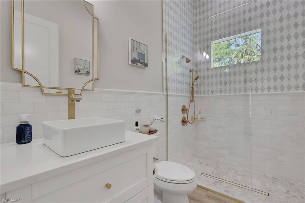 530 1st Street Northwest Naples, FL 34120 - Photo 21 of 35 a bathroom with a sink a toilet and shower