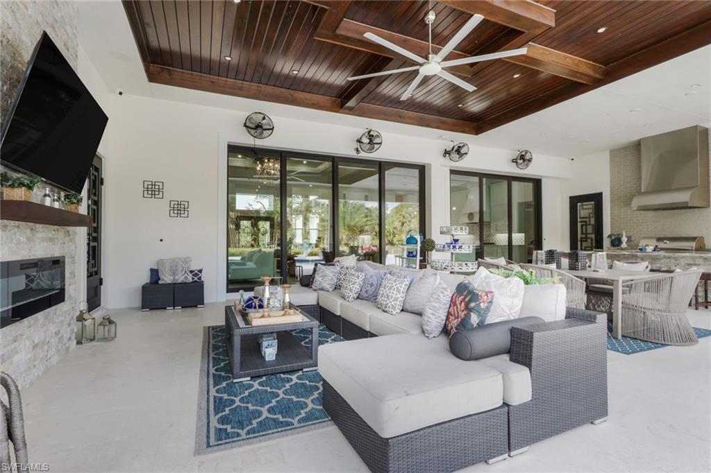 530 1st Street Northwest Naples, FL 34120 - Photo 24 of 35 a living room with fireplace furniture and a flat screen tv