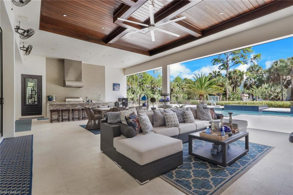 530 1st Street Northwest Naples, FL 34120 - Photo 25 of 35 a living room with patio furniture and a large window