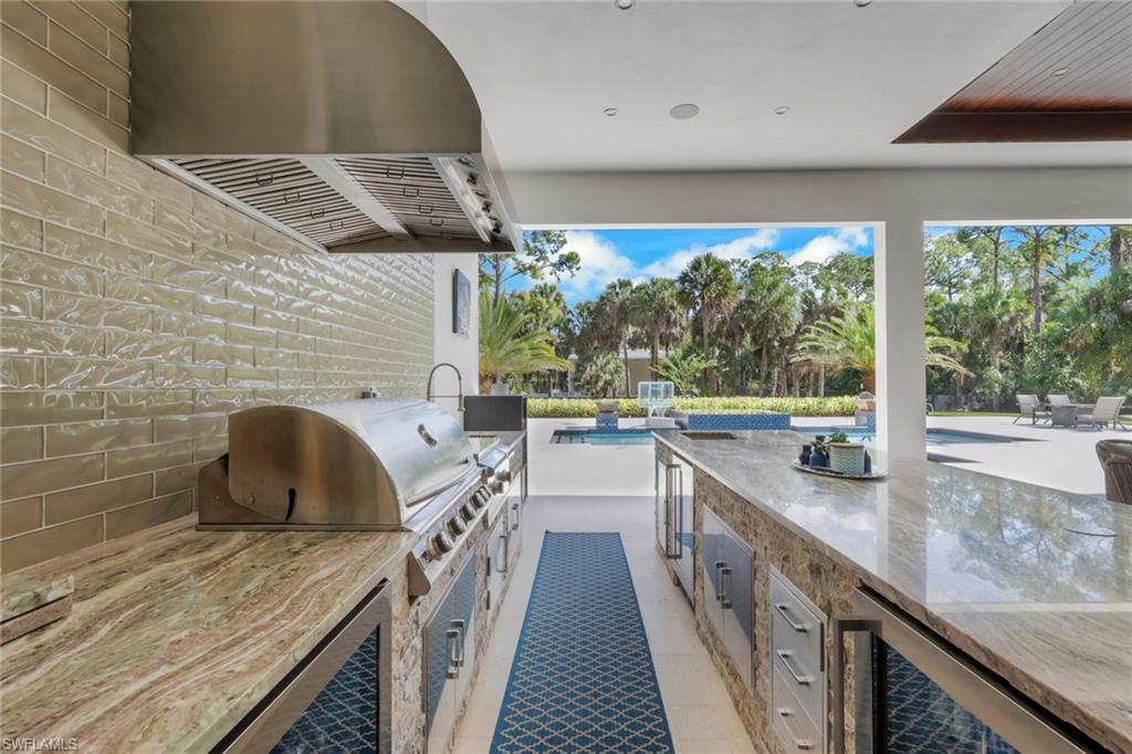 530 1st Street Northwest Naples, FL 34120 - Photo 27 of 35 a kitchen with a sink stove and cabinets
