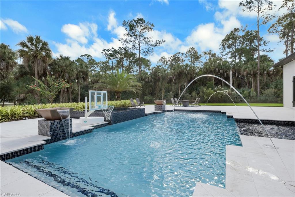 530 1st Street Northwest Naples, FL 34120 - Photo 29 of 35 a view of a backyard with sitting area