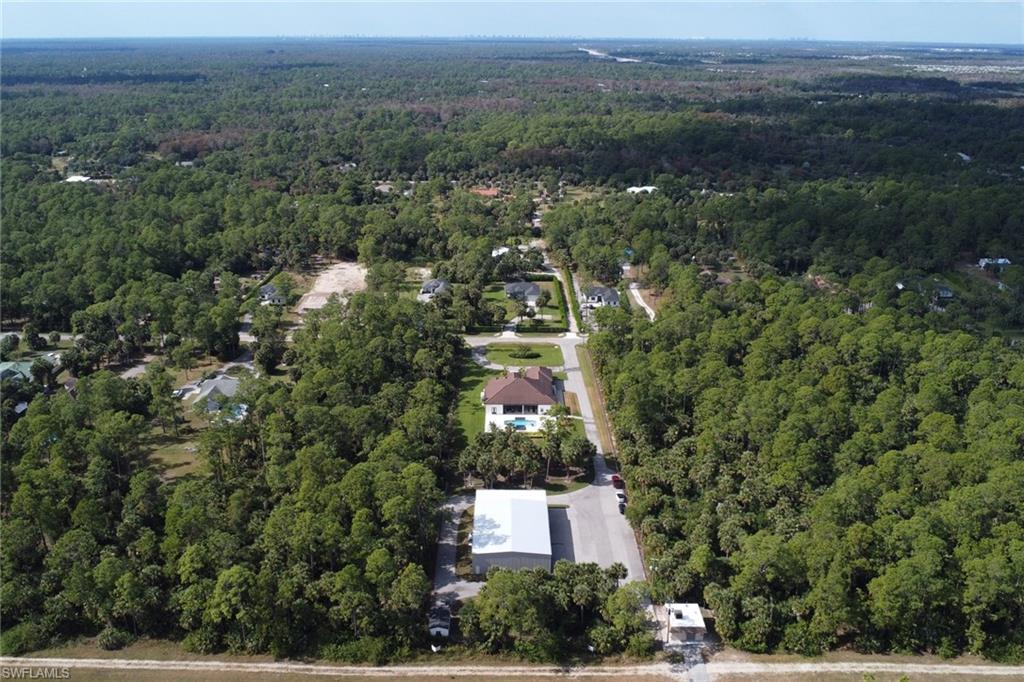 530 1st Street Northwest Naples, FL 34120 - Photo 3 of 35 an aerial view of residential house with outdoor space and trees all around