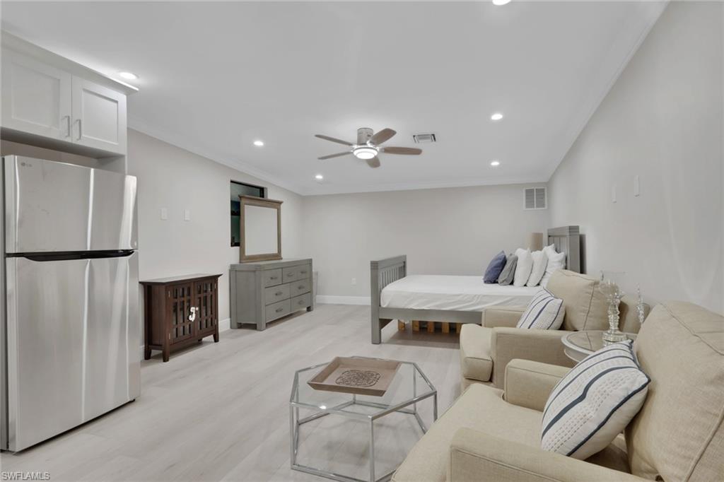 530 1st Street Northwest Naples, FL 34120 - Photo 33 of 35 a living room with furniture and a fireplace