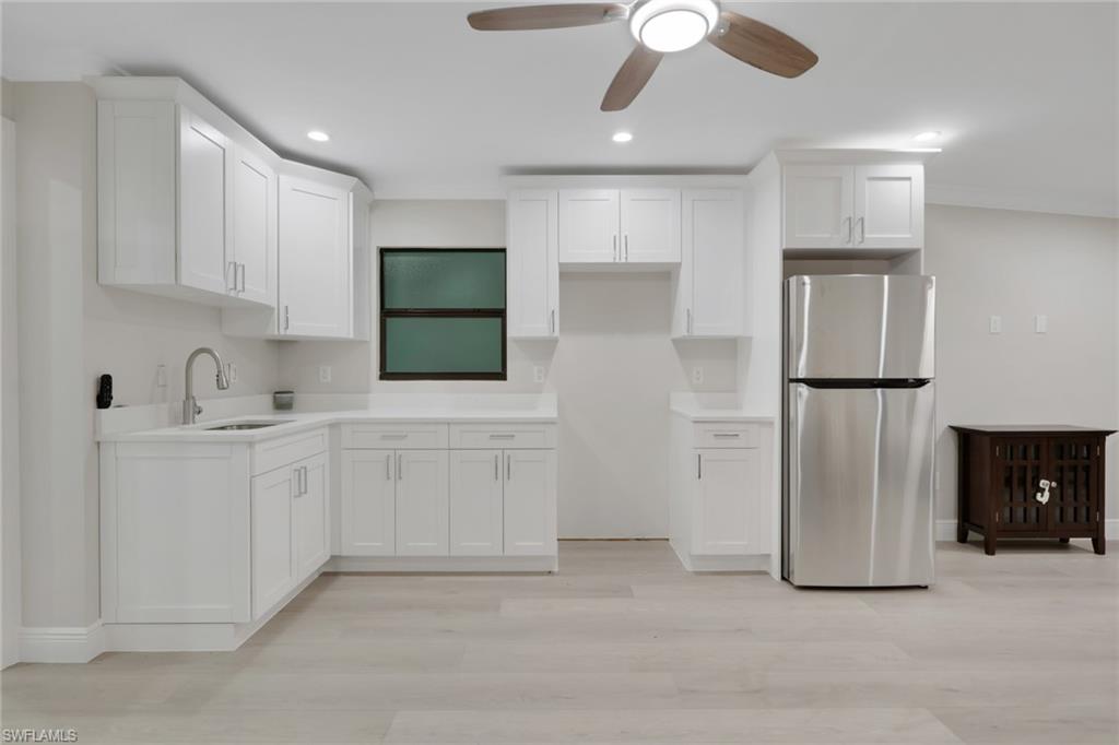 530 1st Street Northwest Naples, FL 34120 - Photo 34 of 35 a kitchen with white cabinets and refrigerator