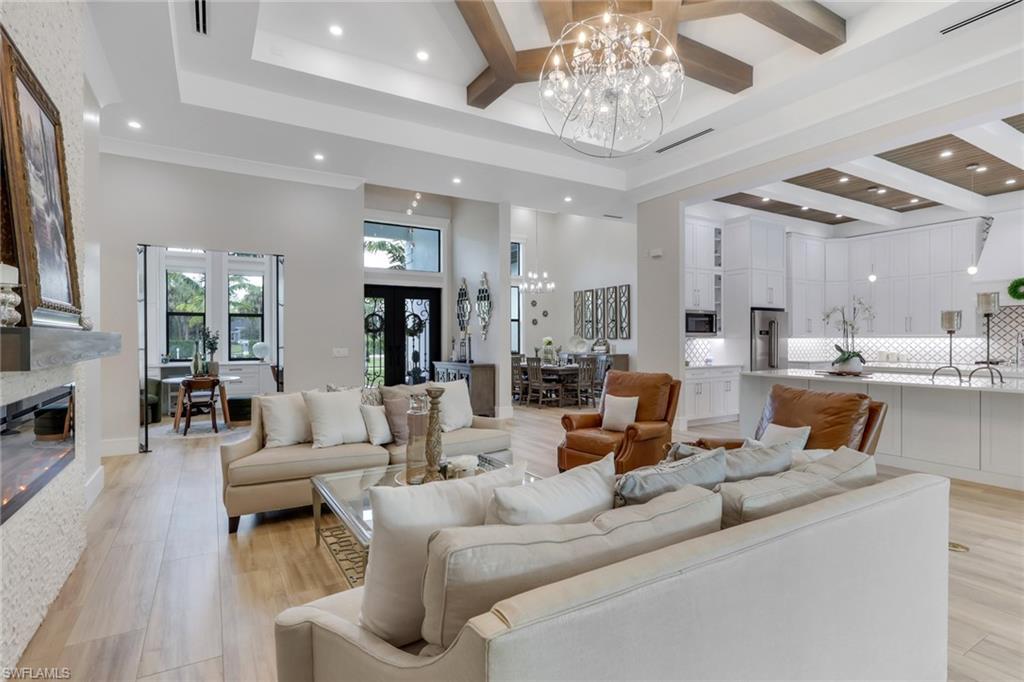 530 1st Street Northwest Naples, FL 34120 - Photo 6 of 35 a living room with furniture and a chandelier