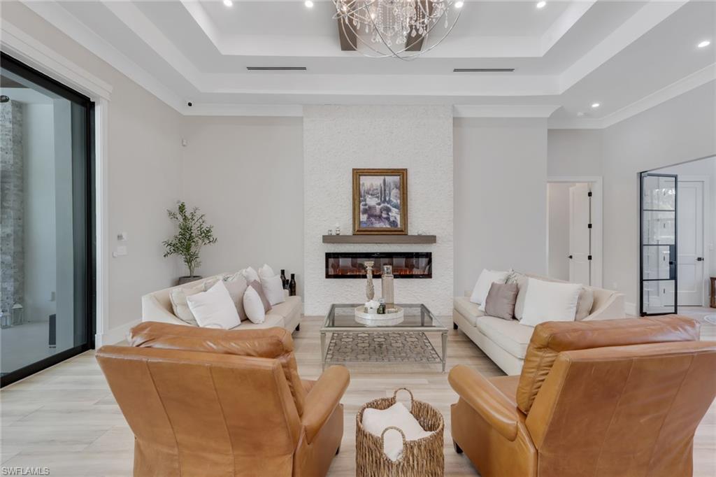 530 1st Street Northwest Naples, FL 34120 - Photo 7 of 35 a living room with furniture and a potted plant
