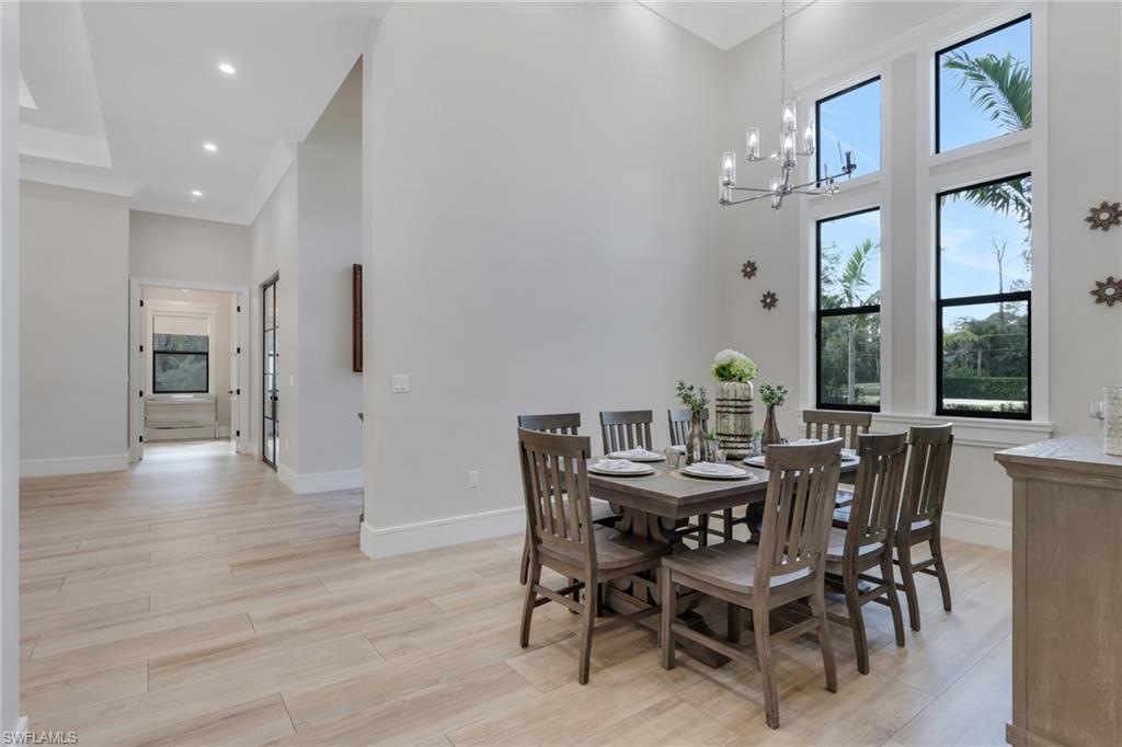 530 1st Street Northwest Naples, FL 34120 - Photo 9 of 35 a view of a dining room with furniture and wooden floor