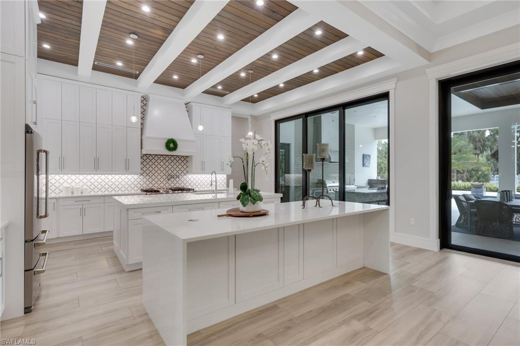 530 1st Street Northwest Naples, FL 34120 - Photo 10 of 35 a large white kitchen with a large window