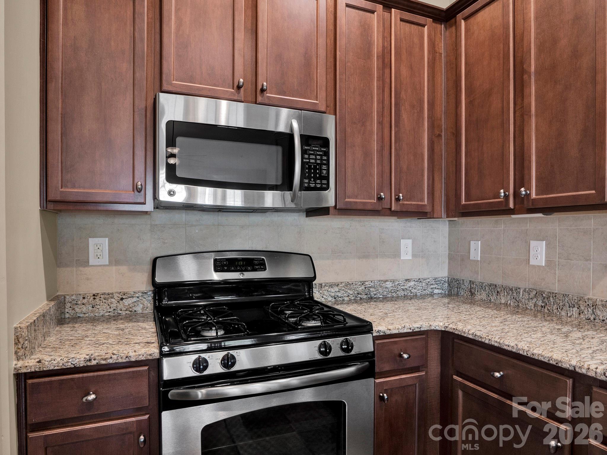 14726 Intermilan Way Charlotte, NC 28277 - Photo 11 of 38 a kitchen with granite countertop a stove and a microwave