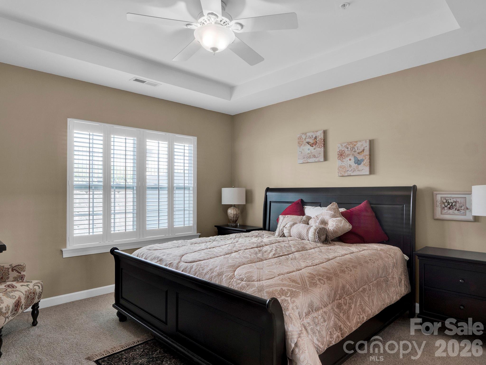 14726 Intermilan Way Charlotte, NC 28277 - Photo 18 of 38 a bedroom with a large bed and a chandelier