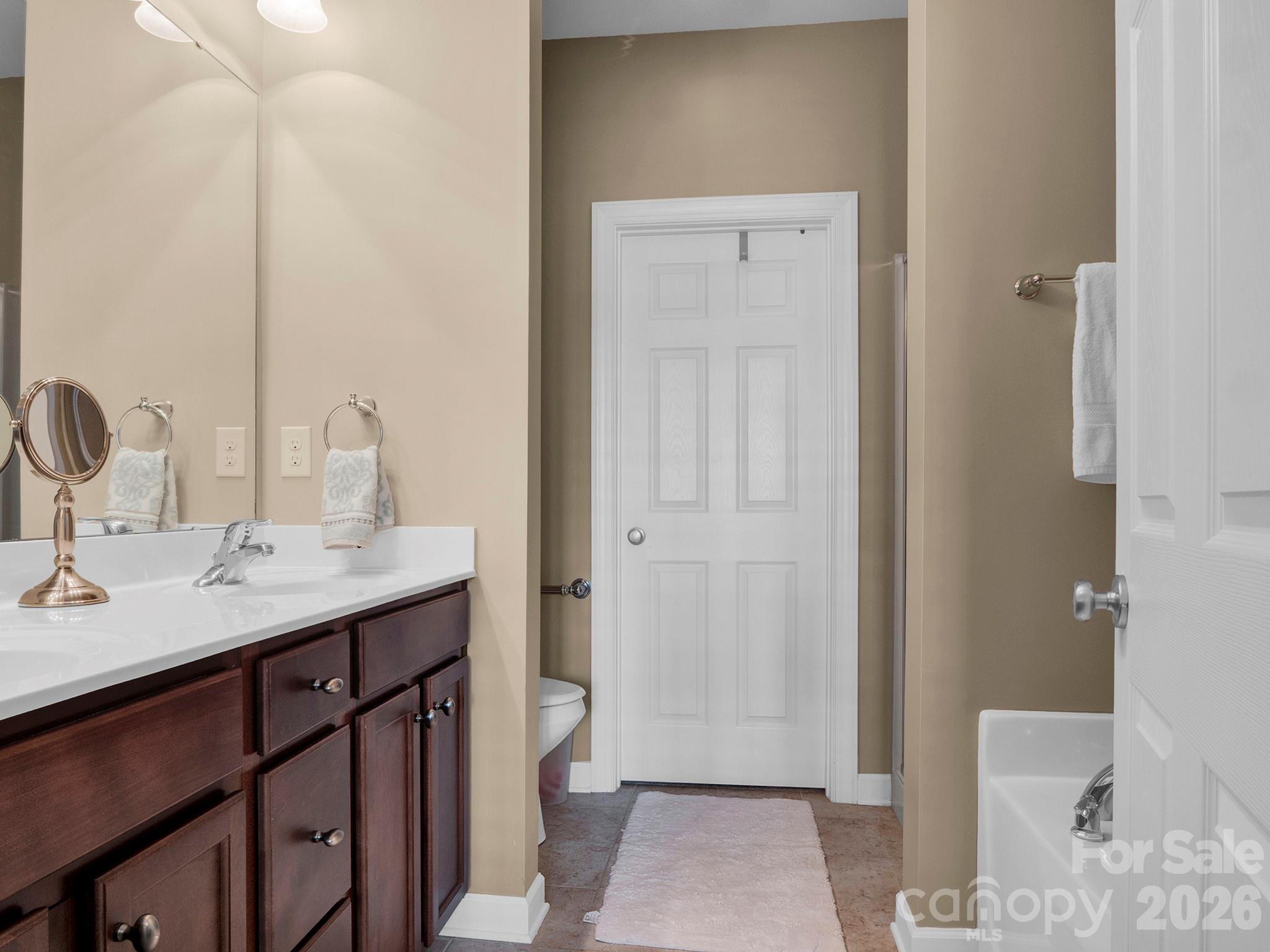 14726 Intermilan Way Charlotte, NC 28277 - Photo 21 of 38 a bathroom with a sink a toilet and shower