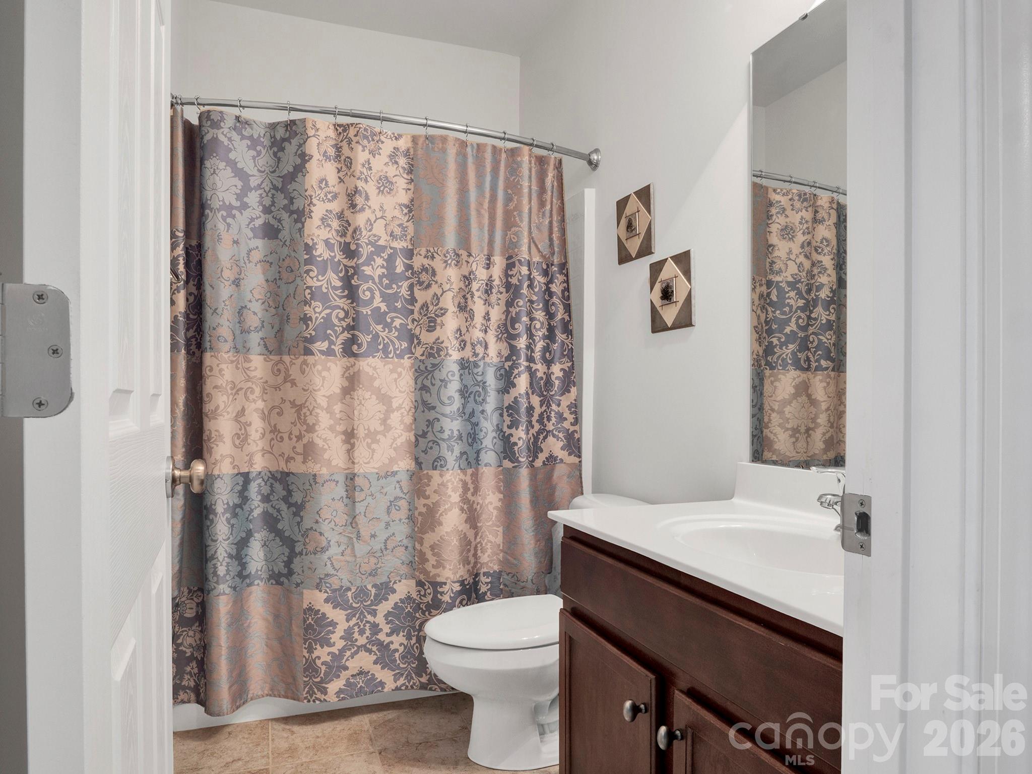 14726 Intermilan Way Charlotte, NC 28277 - Photo 27 of 38 a bathroom with a sink a toilet and shower curtain