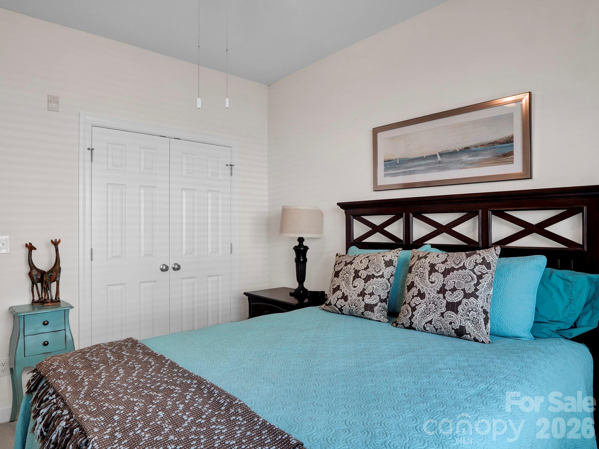 14726 Intermilan Way Charlotte, NC 28277 - Photo 32 of 38 a bedroom with a bed a mirror on dresser and a table