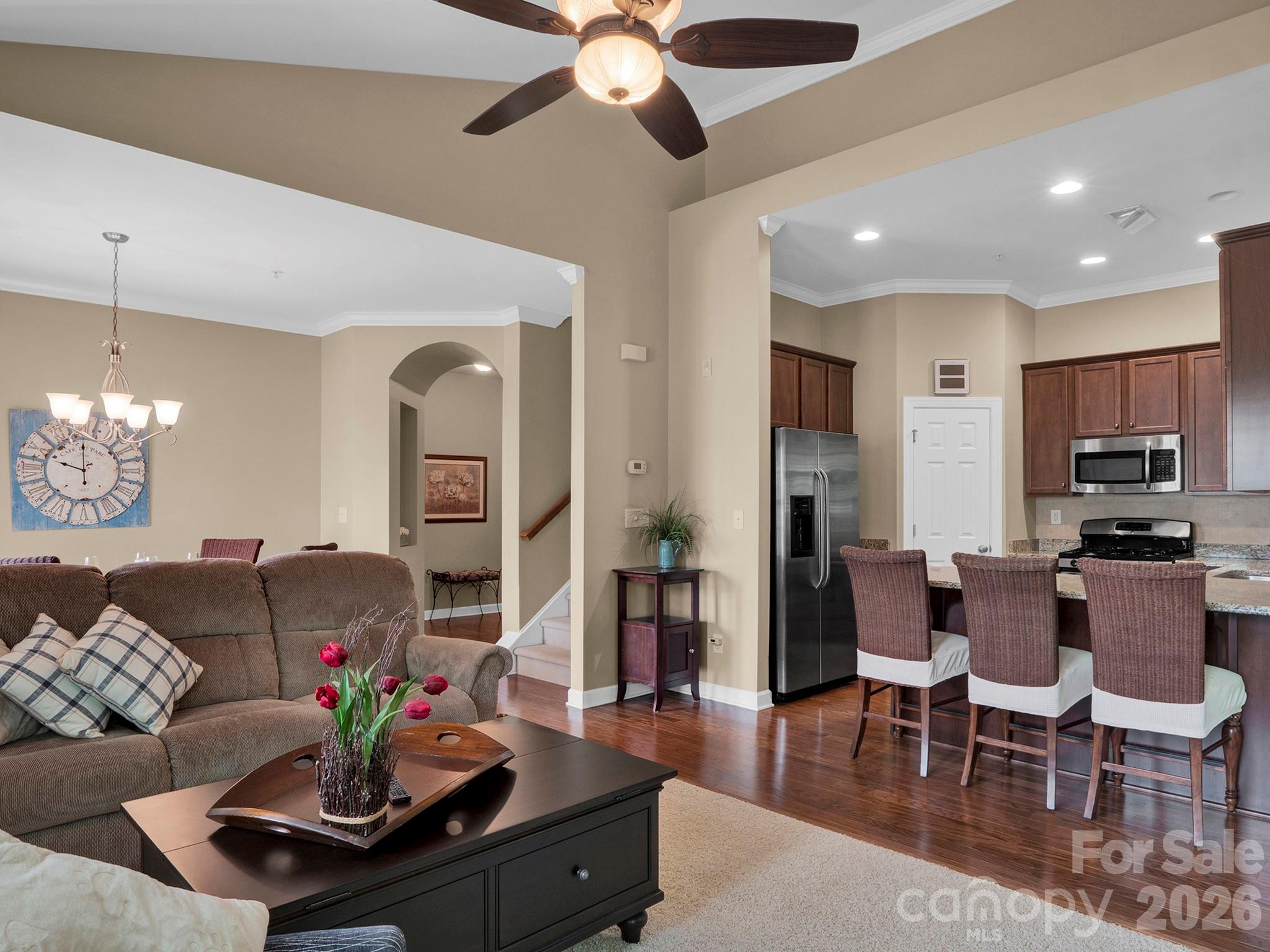 14726 Intermilan Way Charlotte, NC 28277 - Photo 7 of 38 a living room with furniture kitchen view and a chandelier