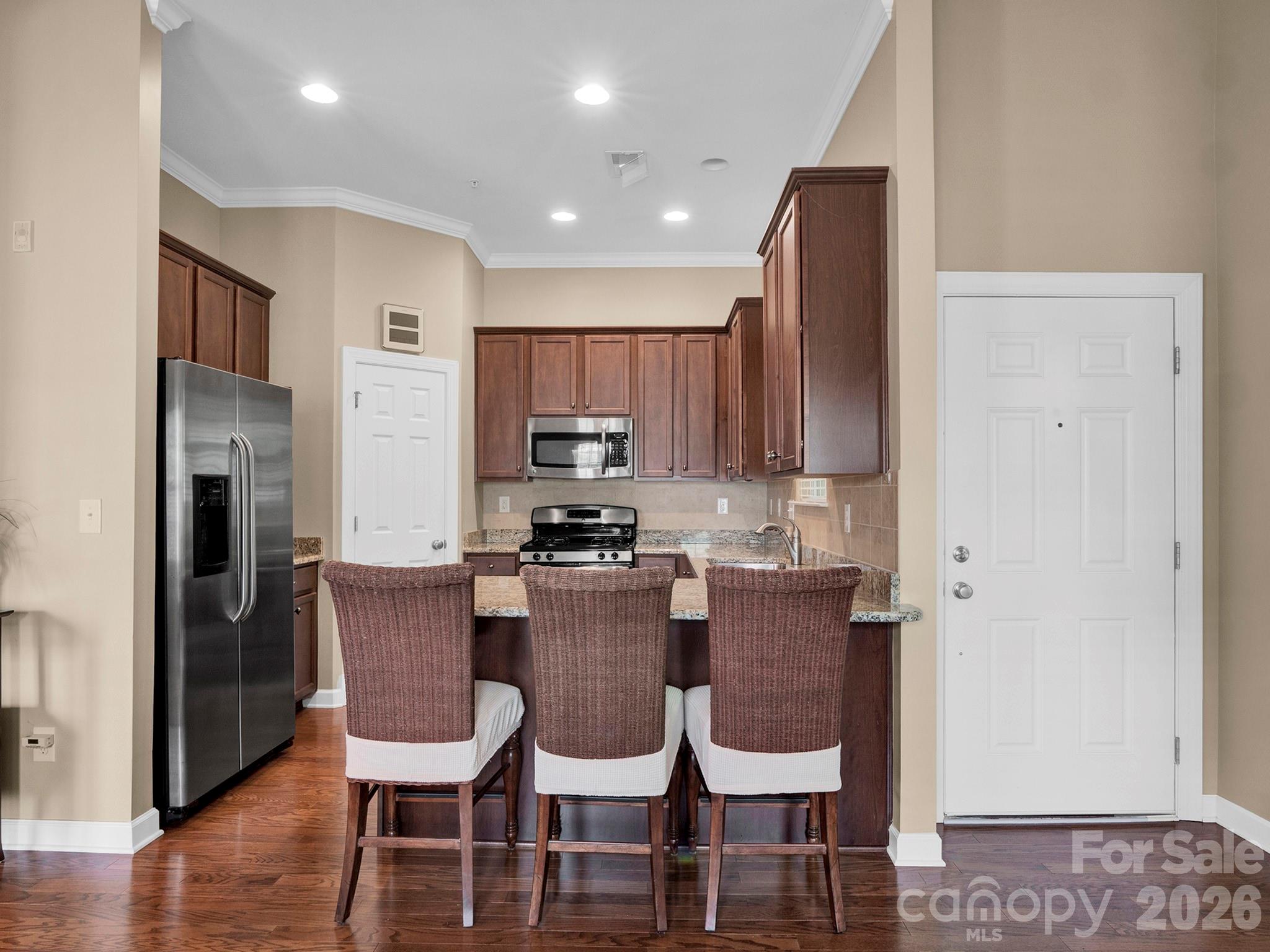 14726 Intermilan Way Charlotte, NC 28277 - Photo 8 of 38 a view of kitchen with cabinets and wooden floor