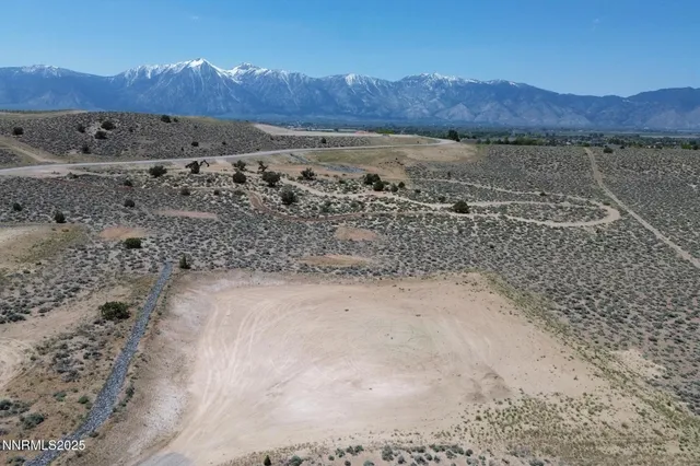 a view of a field with mountains in the background