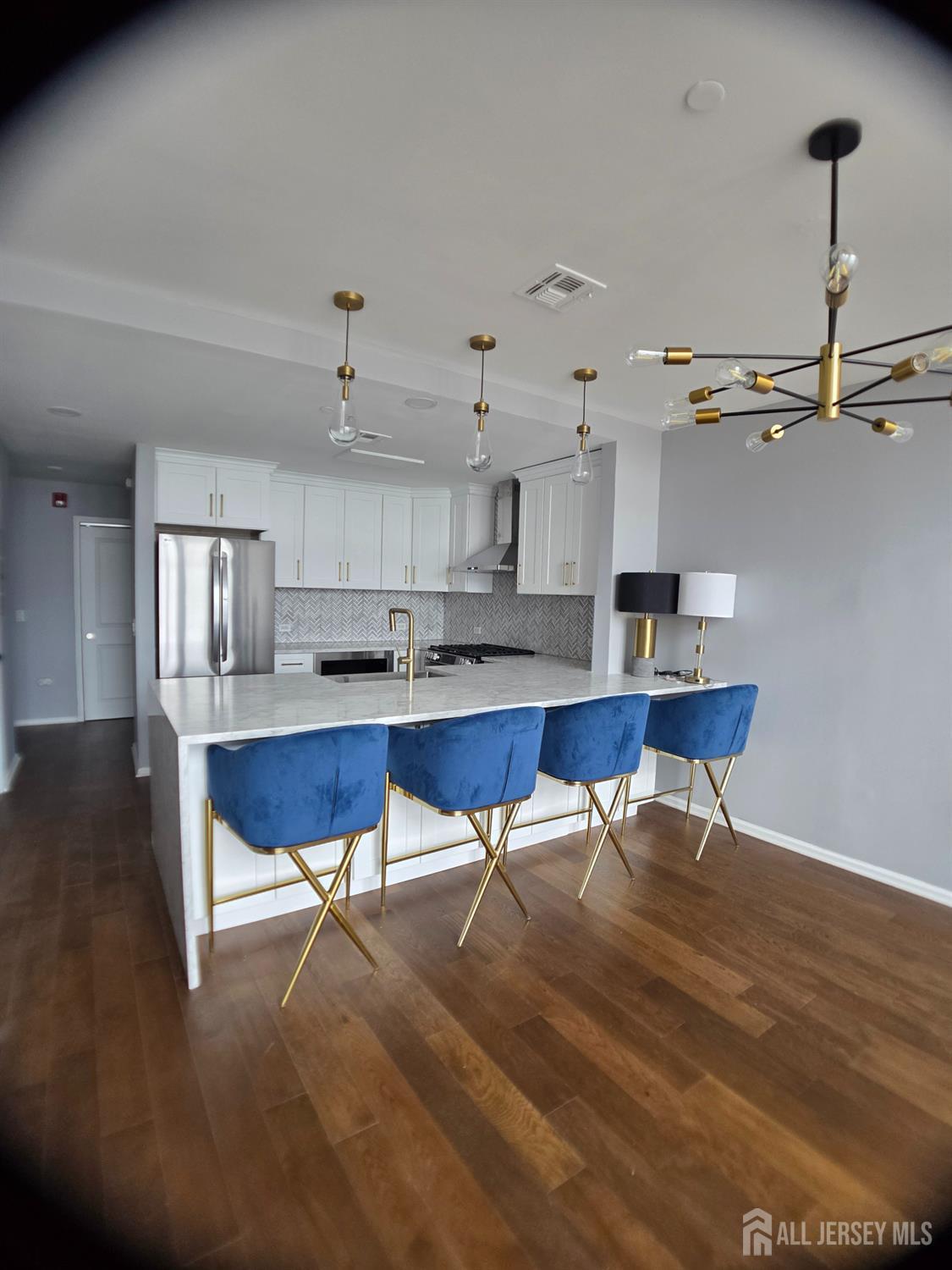 a living room with lots of furniture and kitchen view