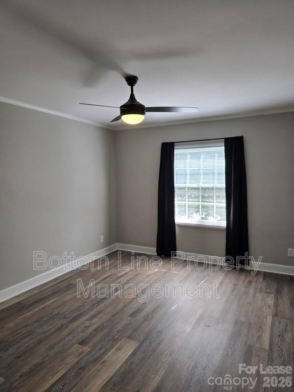 5949 Quail Hollow Road, Unit D Charlotte, NC 28210 - Photo 23 of 34 an empty room with wooden floor and windows