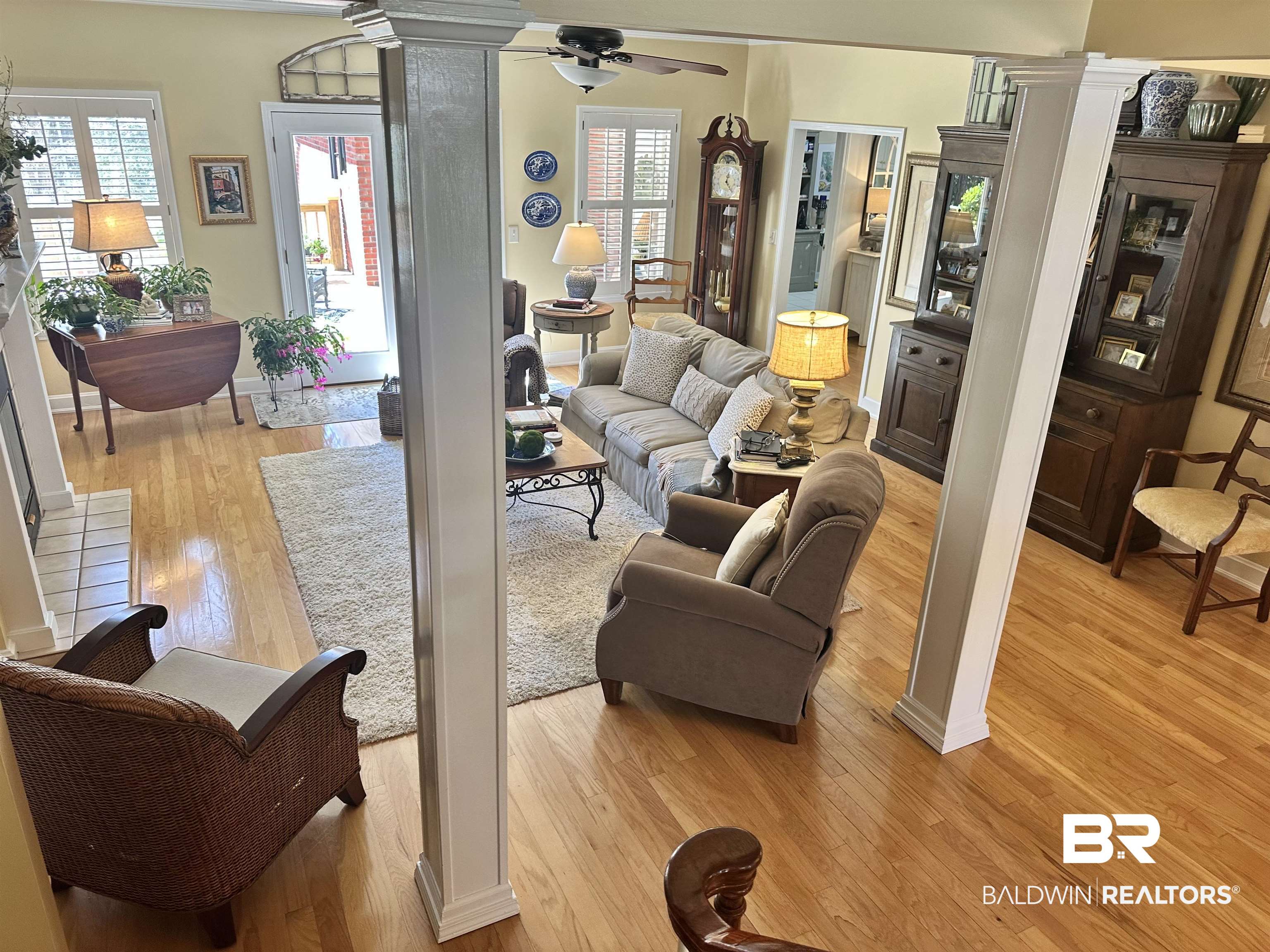 148 Brooks Boulevard Brewton, AL 36426 - Photo 10 of 45 Living area featuring a ceiling fan, light wood-style flooring, a healthy amount of sunlight, and ornate columns