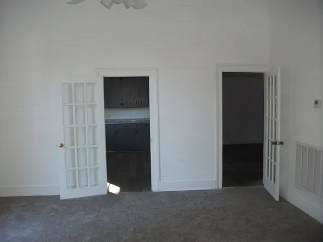 an empty room with closet area