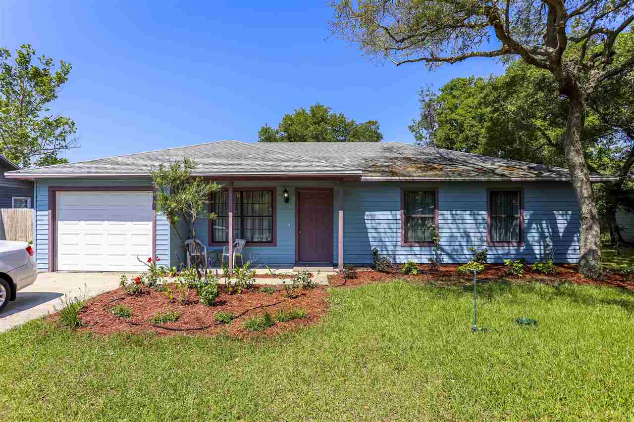 a front view of a house with a yard fire pit and outdoor seating