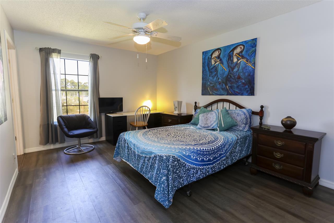 162 Segovia Road St. Augustine, FL 32086 - Photo 19 of 29 a bedroom with a bed and wooden floor
