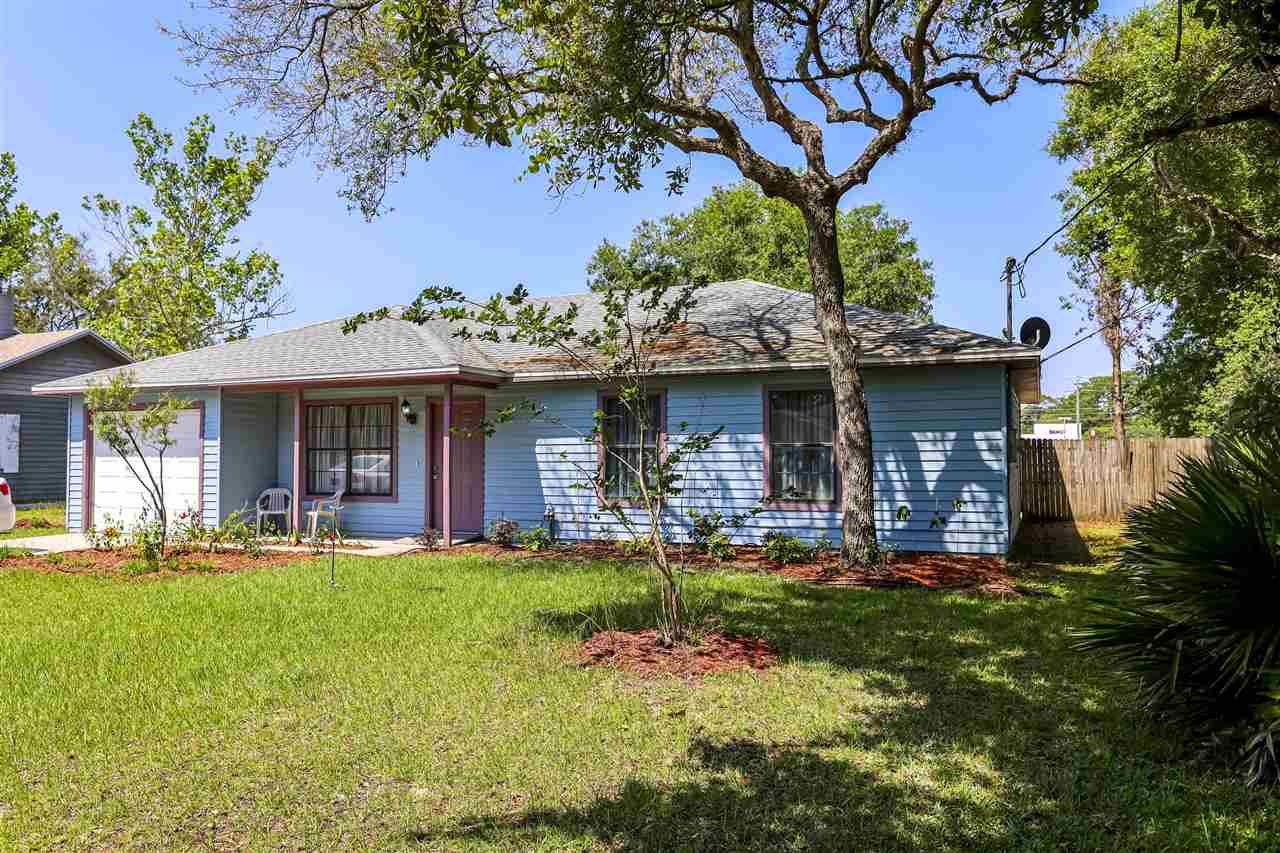 162 Segovia Road St. Augustine, FL 32086 - Photo 29 of 29 a front view of a house with a yard table and chairs
