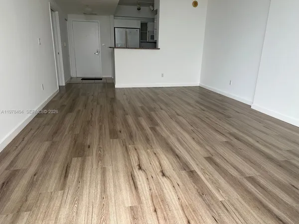 a kitchen with granite countertop a sink and wooden floor