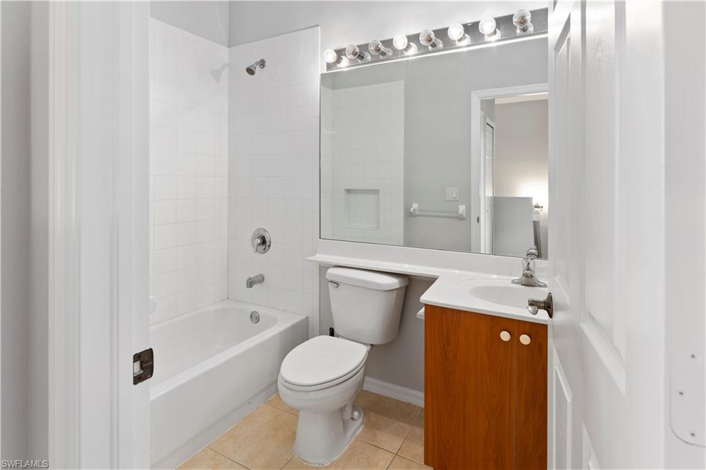 15243 Summit Pl Circle, Unit 247 Naples, FL 34119 - Photo 11 of 18 a bathroom with a sink a toilet and shower