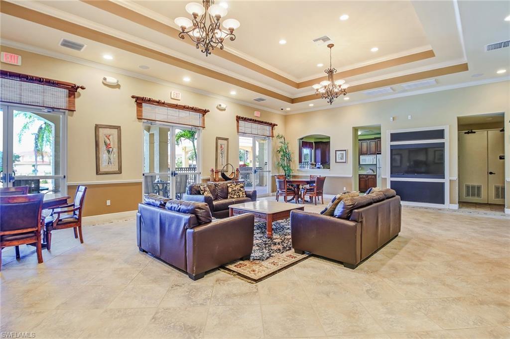 15243 Summit Pl Circle, Unit 247 Naples, FL 34119 - Photo 14 of 18 a living room with furniture and a chandelier